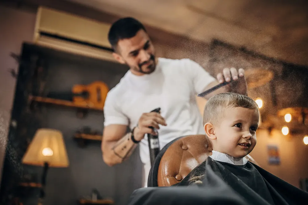 cute-little-boy-at-the-barber-shop-getting-his-royalty-free-image-1675946143